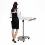 white board that is flat on a stand with lady writing a message