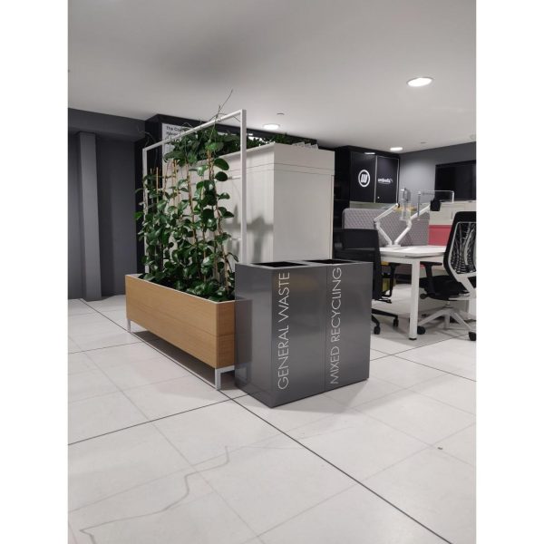 grey office recycling bins with white lettering in office setting