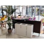 row of 3 white office recycling bins with black lettering in reception area