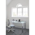 glass desk in room set with office chair