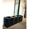 Row of short black office recycling waste bins. With different coloured top and lettering