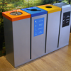 Row of office recycling bins with silver body and different colour tops