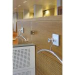 chrome coat hooks on wood divider in office