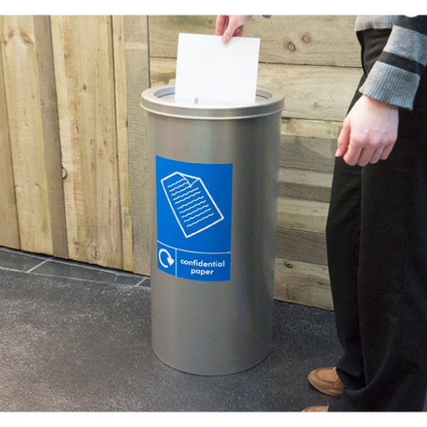 circular office recycling bin in silver finish with blue sticker Confidential Waste