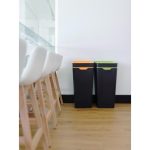 2 black office recycling bins. One with orange lid and one with green