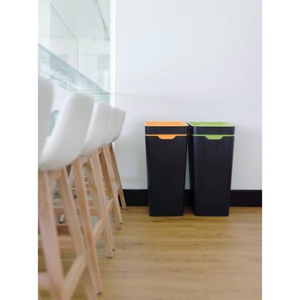 2 black office recycling bins. One with orange lid and one with green