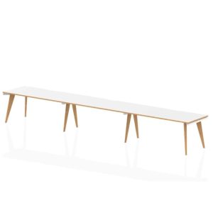 bench style desk in row of 3 with white desk top and wooden legs