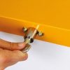 close up of yellow lockable bin top being locked