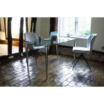 home office desk with clear glass and chrome legs in home office setting with 2 office chairs