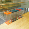 row of 5 transparent office recycling bins with different coloured tops