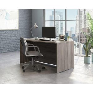 office desk panel end in attractive elm finish . in office setting with office chair and city view