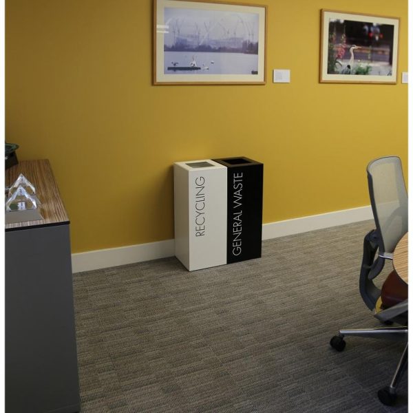 office recycling bins on office with yellow wall. 1 white bin with black lettering recycling and 1 black bin with white lettering General Waste