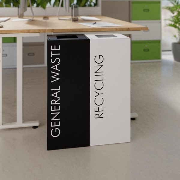 Office recycling bins by side of desk. 1 white with black lettering Recycling and 1 black with white lettering General Waste
