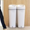 2 white plastic office recycling bins