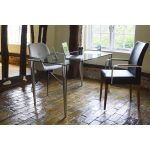 home office desk with glass top and chrome legs in home office room set with 2 office chairs