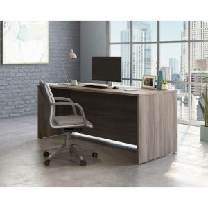 office desk in attractive elm finish with panel end legs. With office chair and city view