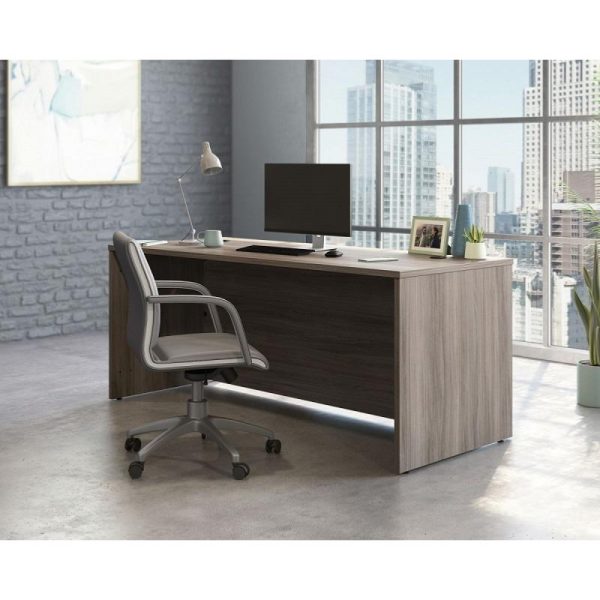 office desk in attractive elm finish with panel end legs. With office chair and city view