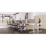 office with row of white desks and grey fabric screens. With white mesh back chairs