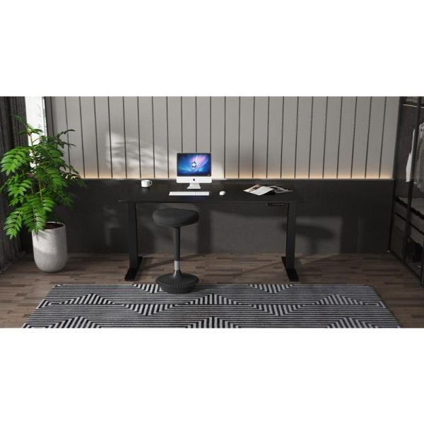 Black height adjustable desk with computer and plant, set an black and white rug