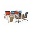 bench desk back to back with white desk top and wooded legs. Black mesh back chairs with colourful orange design fabric