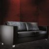 black leather sofa with silver feet in dark room
