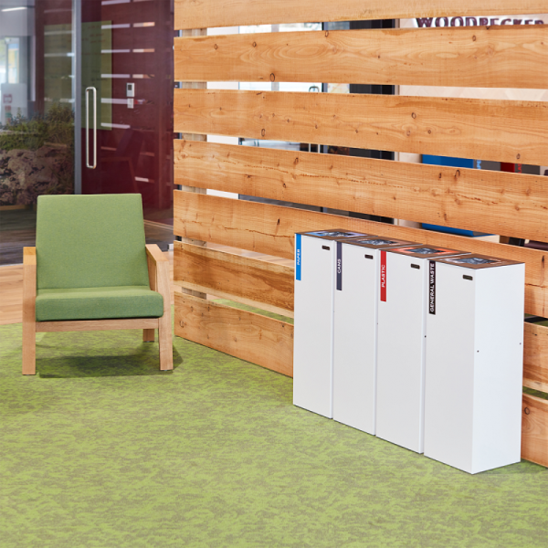 row of white office recycling bins with different coloured sticker