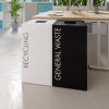 office recycling bins by side of desk, 1 white with black lettering Recycling and 1 black with white lettering General Waste