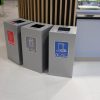 3 silver office recycling bins with different stickers to indicate waste stream in catering environment