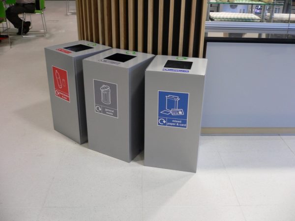 3 silver office recycling bins with different stickers to indicate waste stream in catering environment