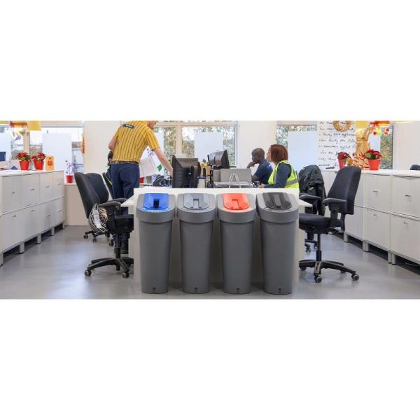 office scene with 4 office recycling bins at end of desk