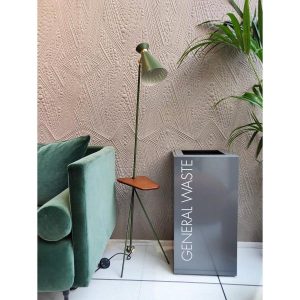 grey office recycling bin with white lettering with green sofa