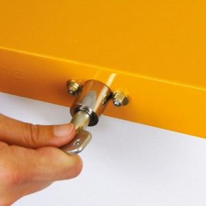 close up of yellow recycling bin locking lid bin top being locked