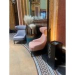 Traditional reception area with black office recycling bin with white lettering Recycling