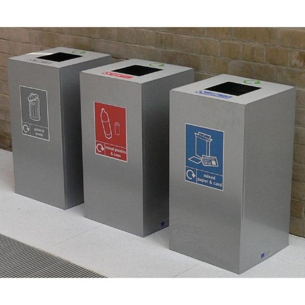 stylish office recycling bins in a row. Silver finish with recycling labels to indicate waste stream