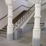 office recycling bins silver in public area by stairs