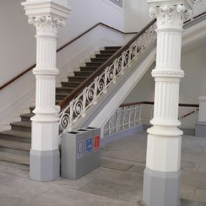 office recycling bins silver in public area by stairs