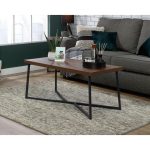 oak coffee table with black frame in room set by sofa